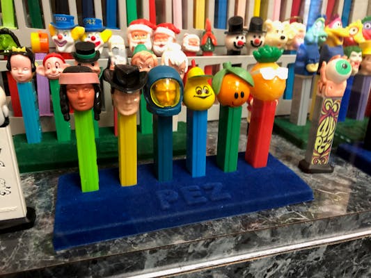 Six antique Pez dispensers on display