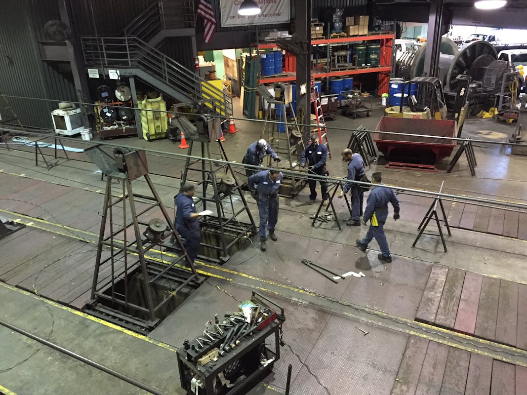 Technicians replacing a cable.