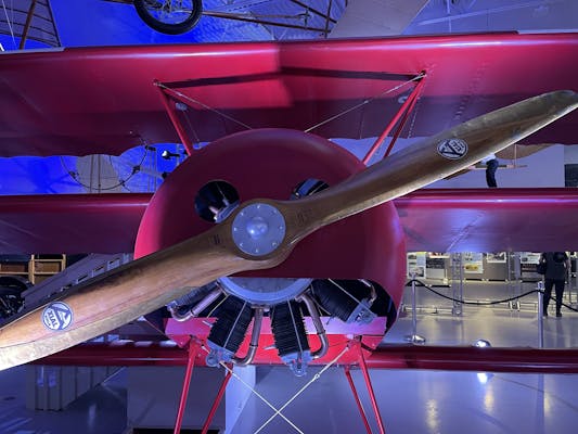 A red biplane in the museum.