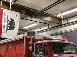 The bulb hanging from the fire station ceiling.