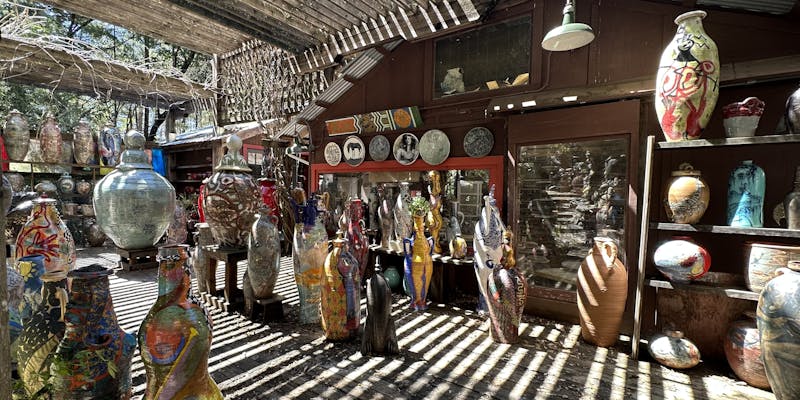 Pots, pots - so many beautiful pots. They are enormous, and brightly coloured, and jumbled together in an outdoor space.