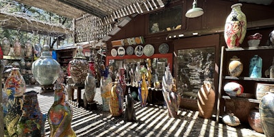 Pots, pots - so many beautiful pots. They are enormous, and brightly coloured, and jumbled together in an outdoor space.