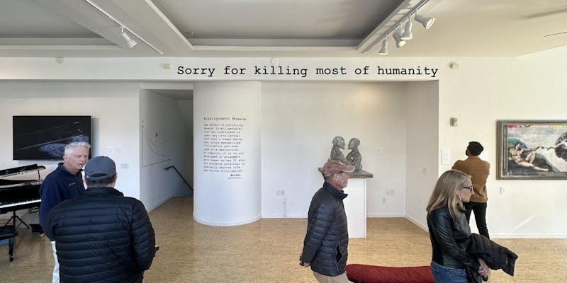 A sign above the gallery wall reads Sorry for killing most of humanity