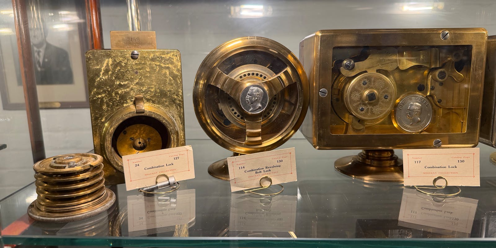 A gallery of old wooden display cabinets with black and white photos lining the wall.