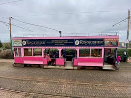 A beautiful pink tram.