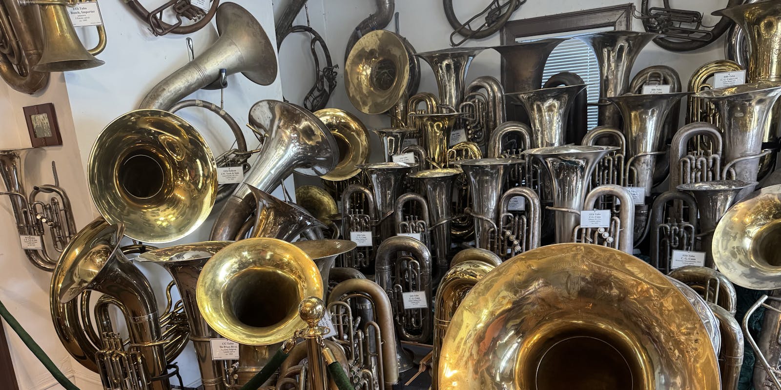 Over a dozen varied tubas in excellent condition, each with a neat label.